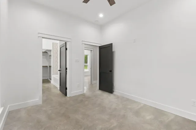 an empty room with a cabinet and a mirror