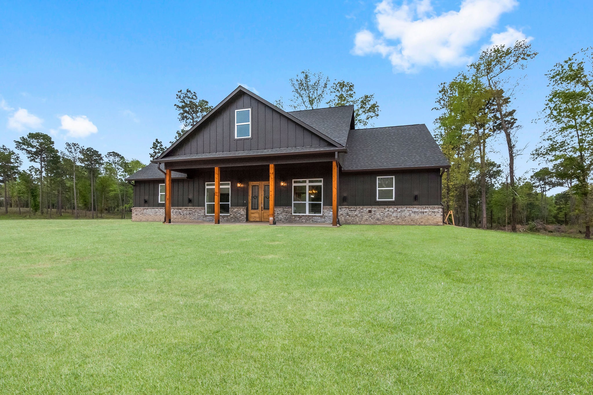 393 Hanson Road Onalaska, TX 77360 - Photo 2 of 38 a front view of a house with a garden