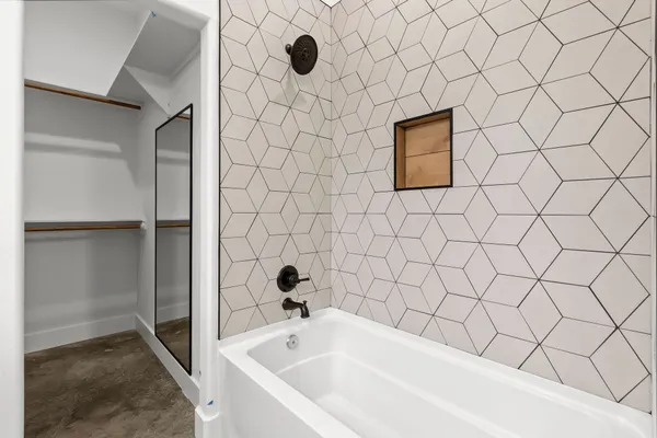 a bathroom with a bathtub and shower