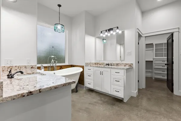 a bathroom with a granite countertop sink double vanity and a mirror