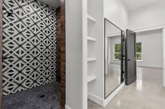 a bathroom with a shower and a glass door