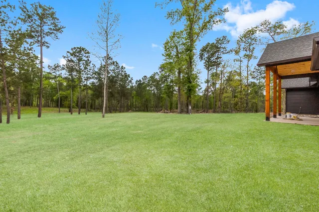 a view of outdoor space with deck and yard
