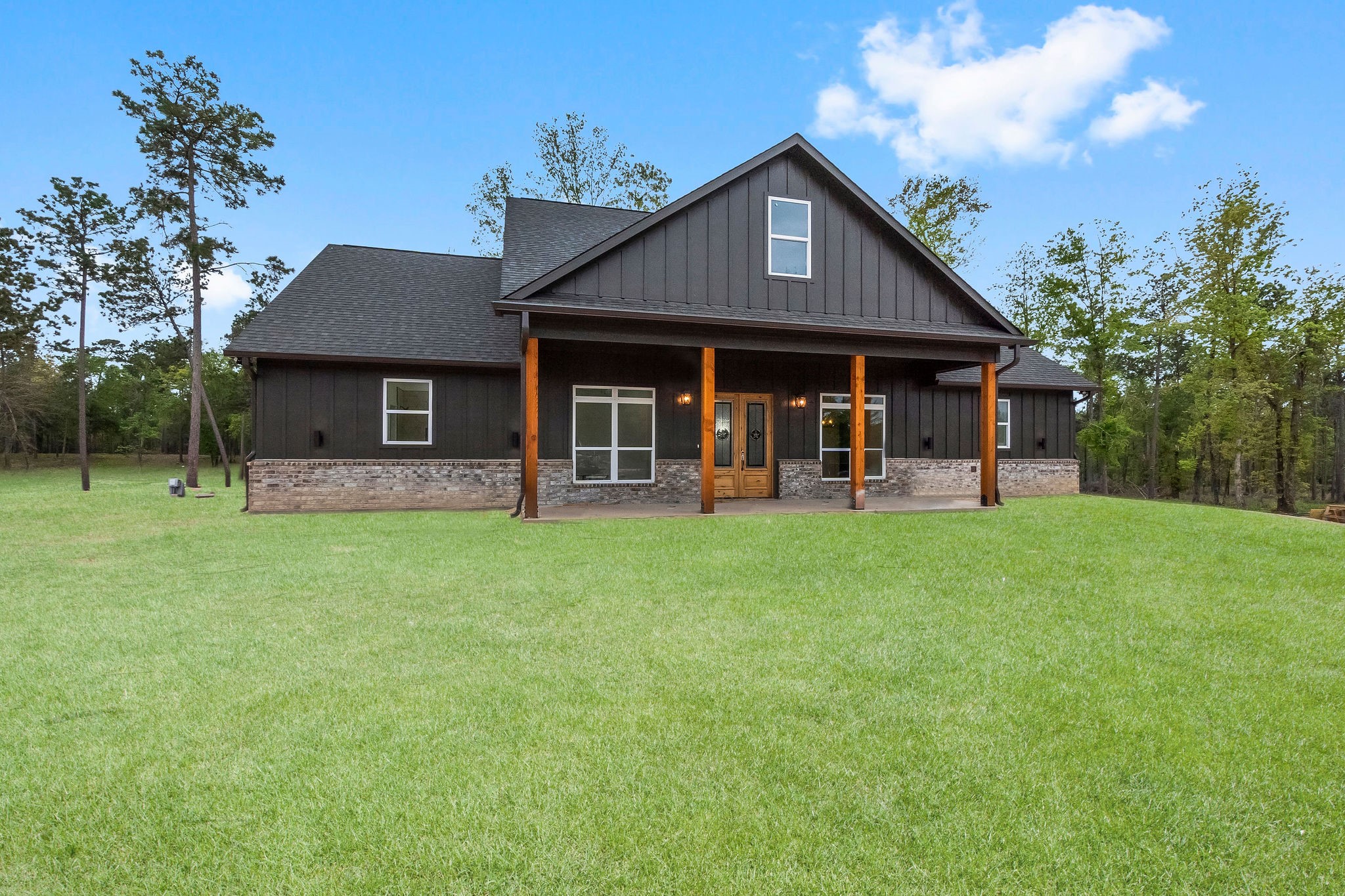 393 Hanson Road Onalaska, TX 77360 - Photo 5 of 38 a front view of a house with a yard