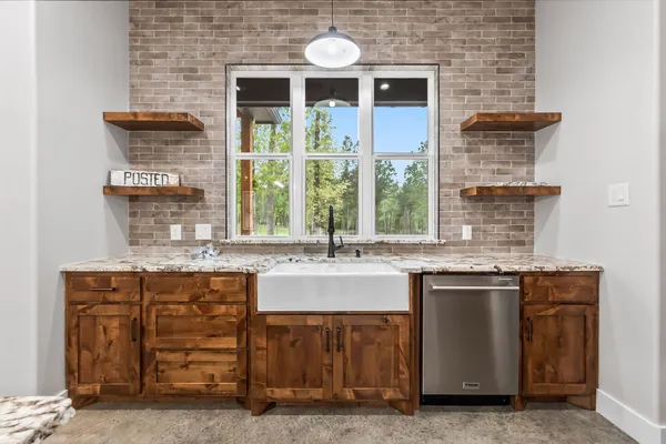 a kitchen with stainless steel appliances granite countertop a stove and a sink