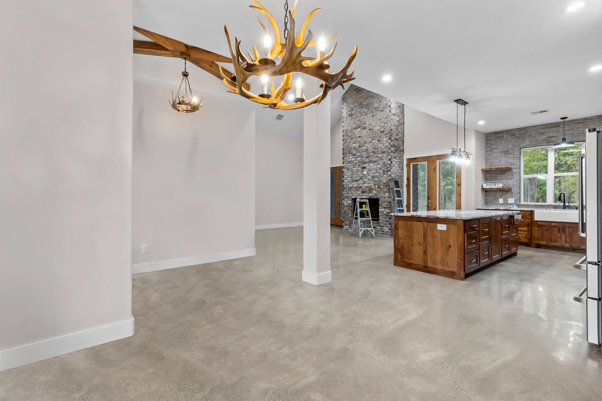 393 Hanson Road Onalaska, TX 77360 - Photo 10 of 38 a large room with chandelier fan and windows