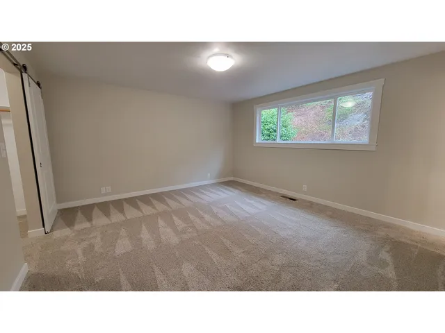 a spacious bathroom with a granite countertop sink a toilet and shower