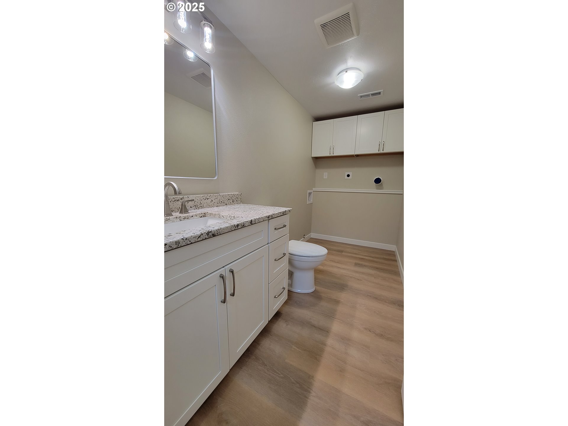 552 West D Street Springfield, OR 97477 - Photo 19 of 29 a bathroom with a granite countertop toilet sink and mirror