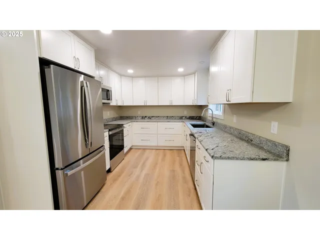 a kitchen with white cabinets
