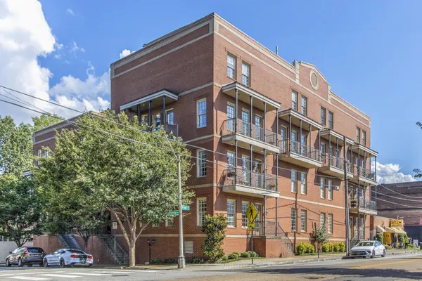 a bathroom with a granite countertop sink a toilet a mirror and shower