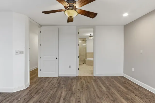 a view of a hallway with wooden floor and entryway