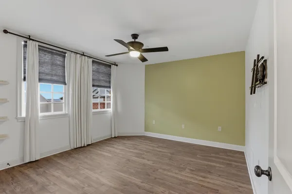 a view of an empty room with a fireplace and a window