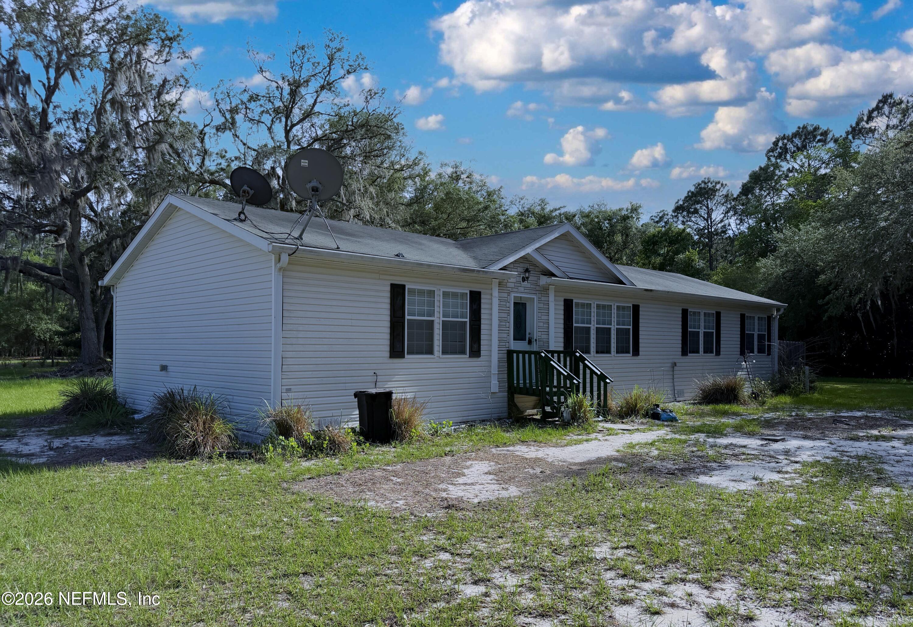136 Short Pine Road Hawthorne, FL 32640 - Photo 2 of 39 a front view of a house with a yard and seating space