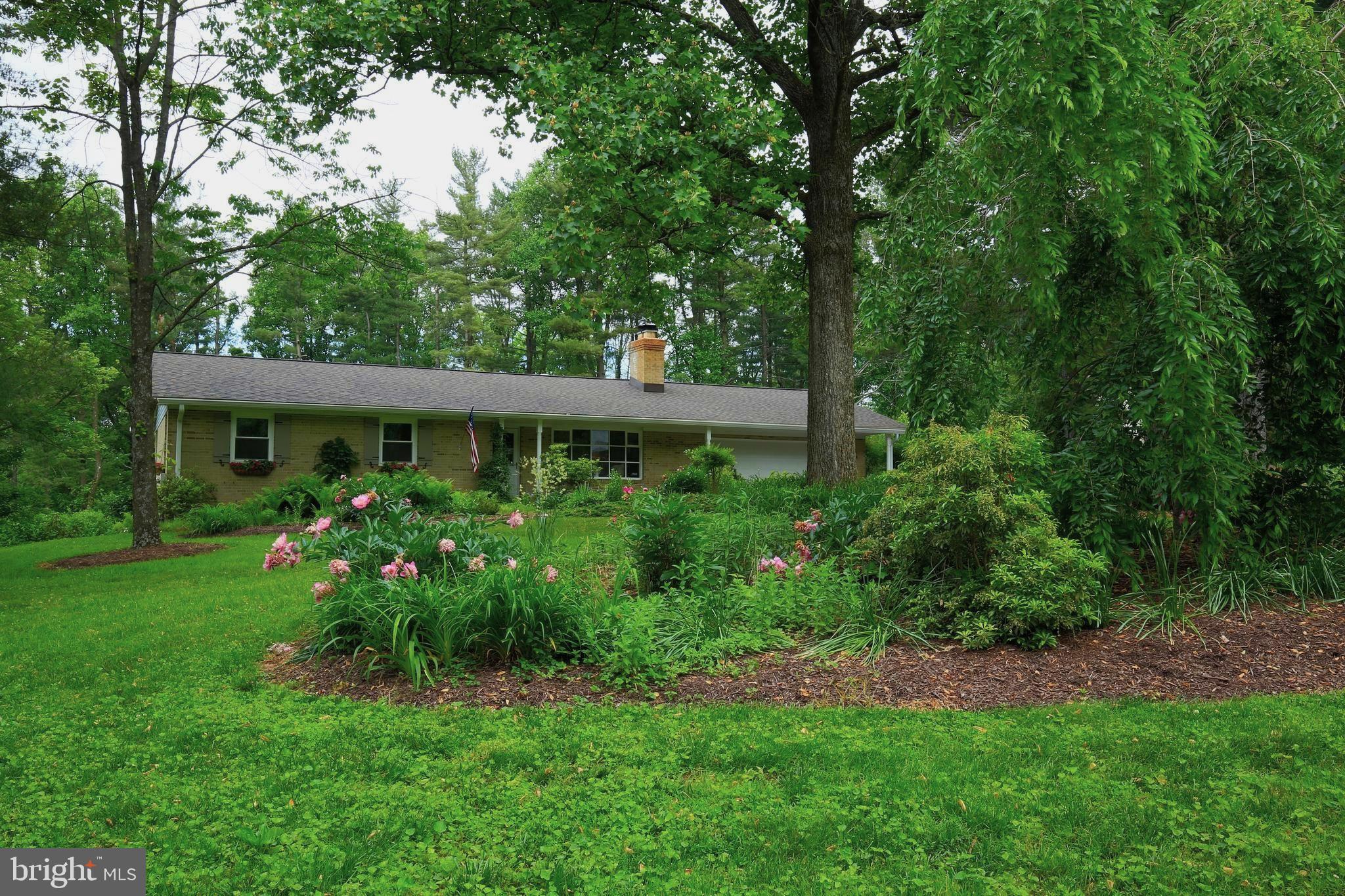 5506 Woodlyn Road Frederick, MD 21703 - Photo 2 of 51 a view of a house with a big yard and large trees