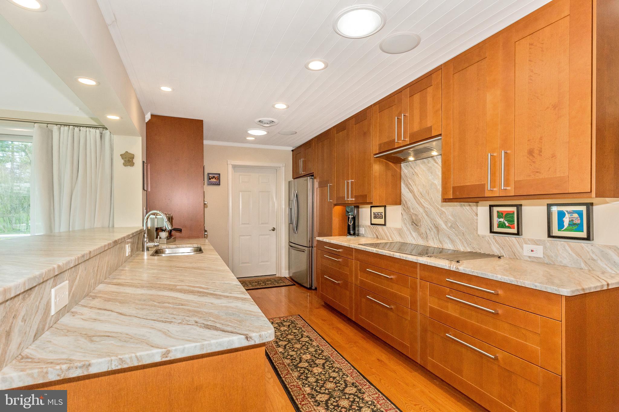 5506 Woodlyn Road Frederick, MD 21703 - Photo 11 of 51 a large kitchen with kitchen island a sink appliances and a counter space
