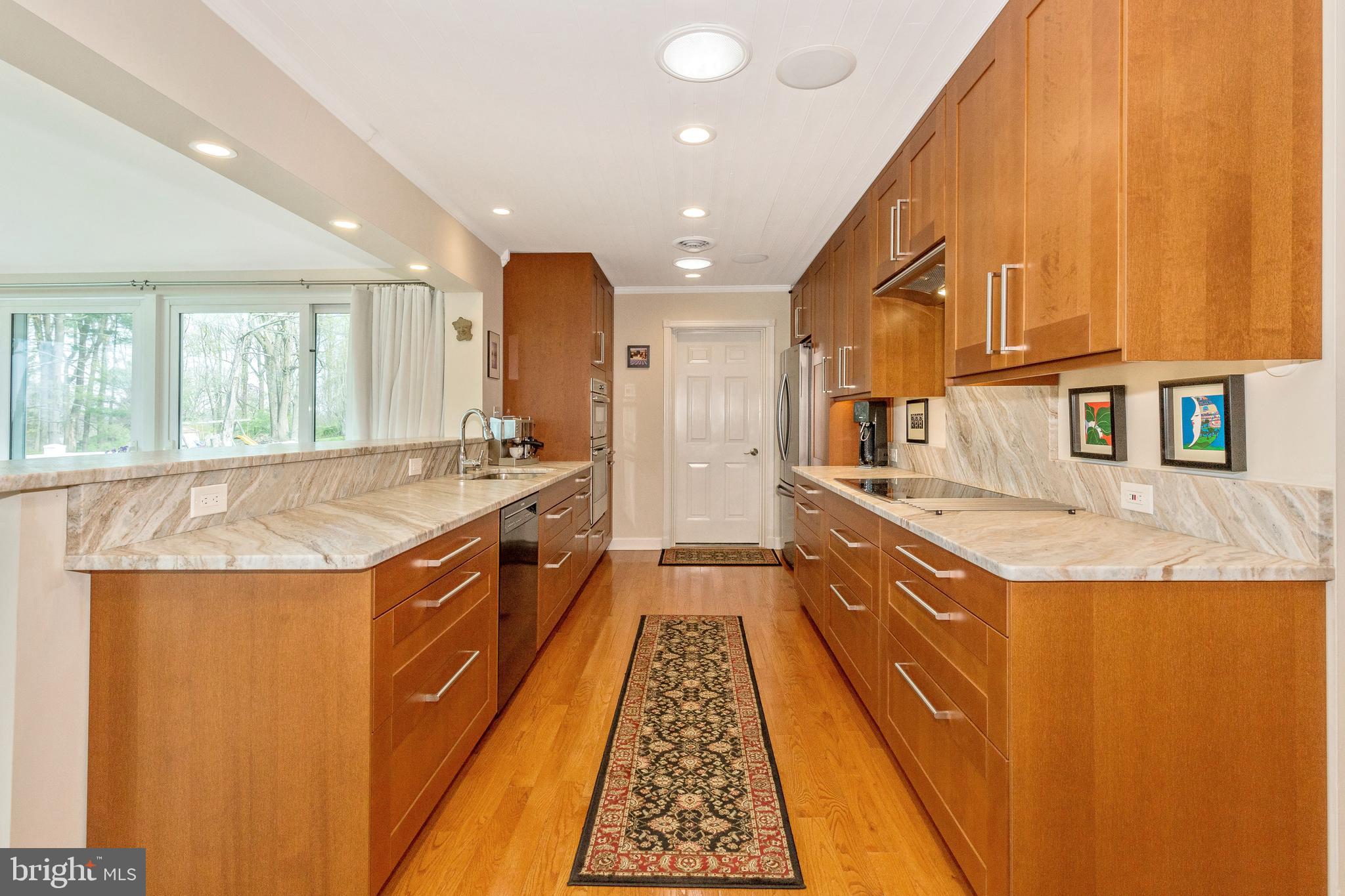 5506 Woodlyn Road Frederick, MD 21703 - Photo 12 of 51 a large kitchen with stainless steel appliances granite countertop a sink and cabinets