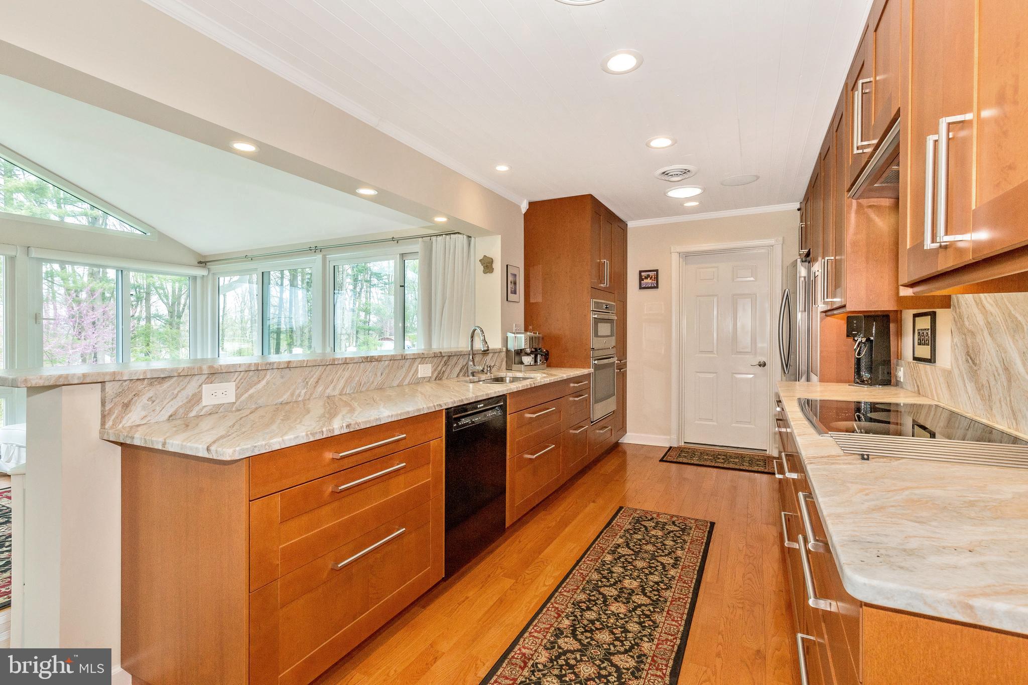 5506 Woodlyn Road Frederick, MD 21703 - Photo 13 of 51 a spacious bathroom with a granite countertop sink and a large mirror