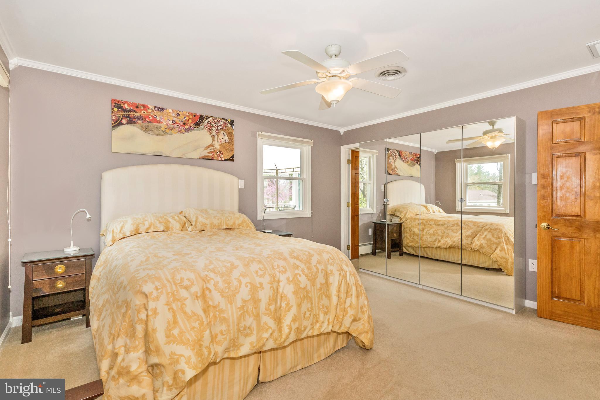 5506 Woodlyn Road Frederick, MD 21703 - Photo 22 of 51 a spacious bedroom with a bed and glass walk in closet