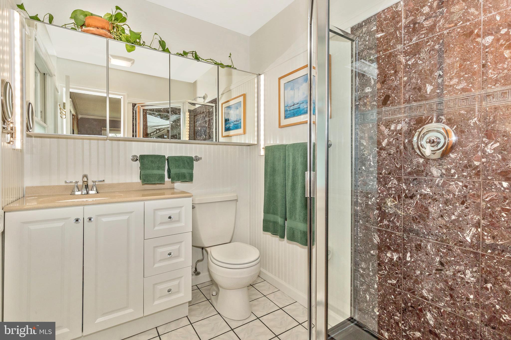 5506 Woodlyn Road Frederick, MD 21703 - Photo 23 of 51 a bathroom with a granite countertop sink toilet and shower