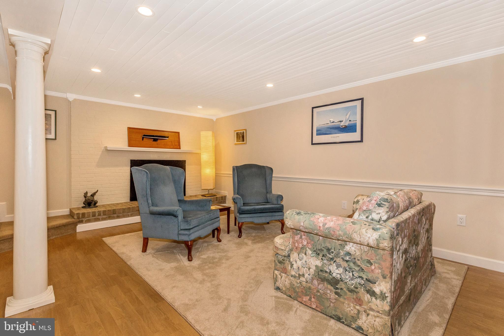 5506 Woodlyn Road Frederick, MD 21703 - Photo 29 of 51 a living room with furniture and a chair