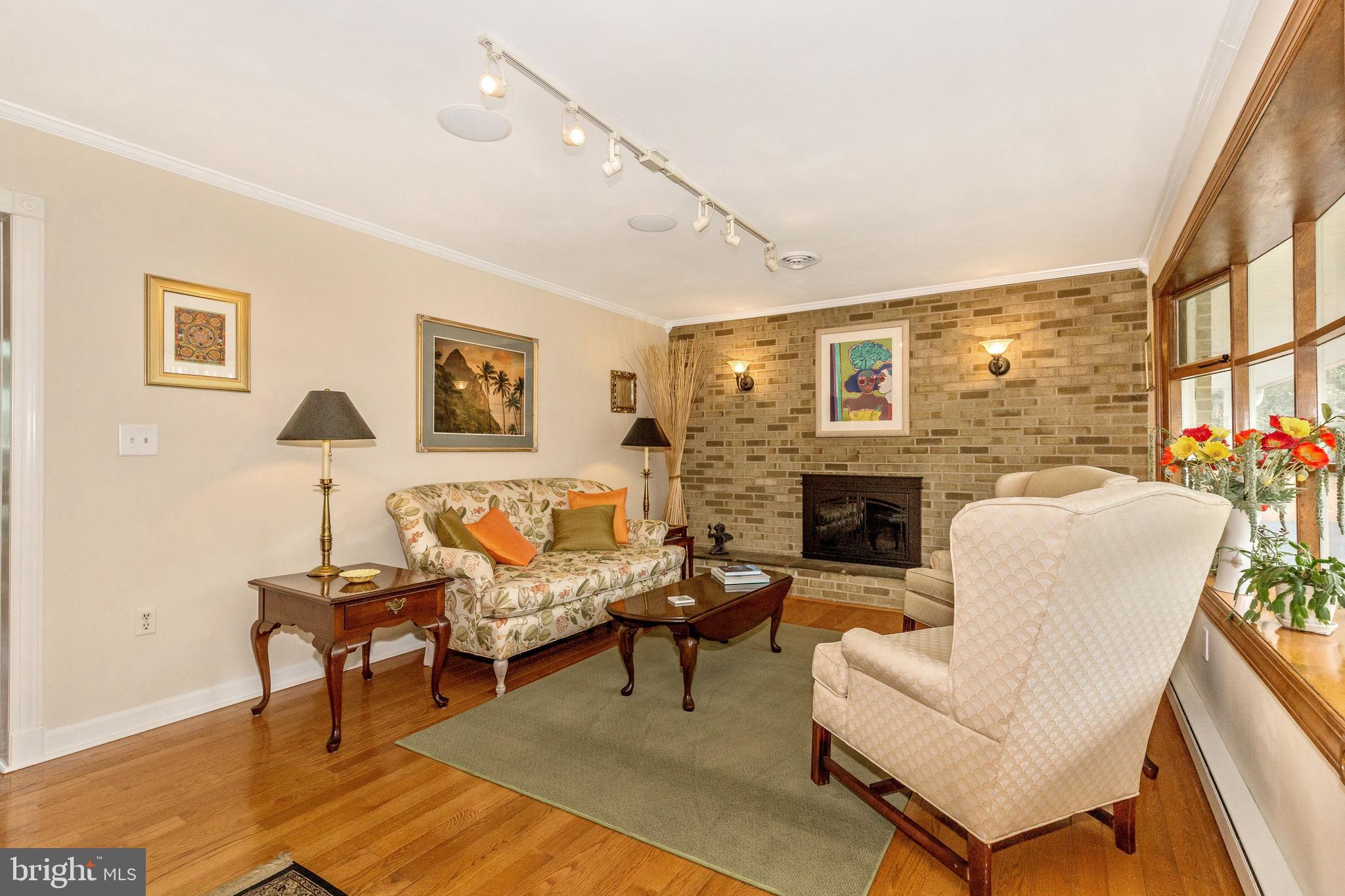 5506 Woodlyn Road Frederick, MD 21703 - Photo 4 of 51 a living room with furniture a fireplace and a table