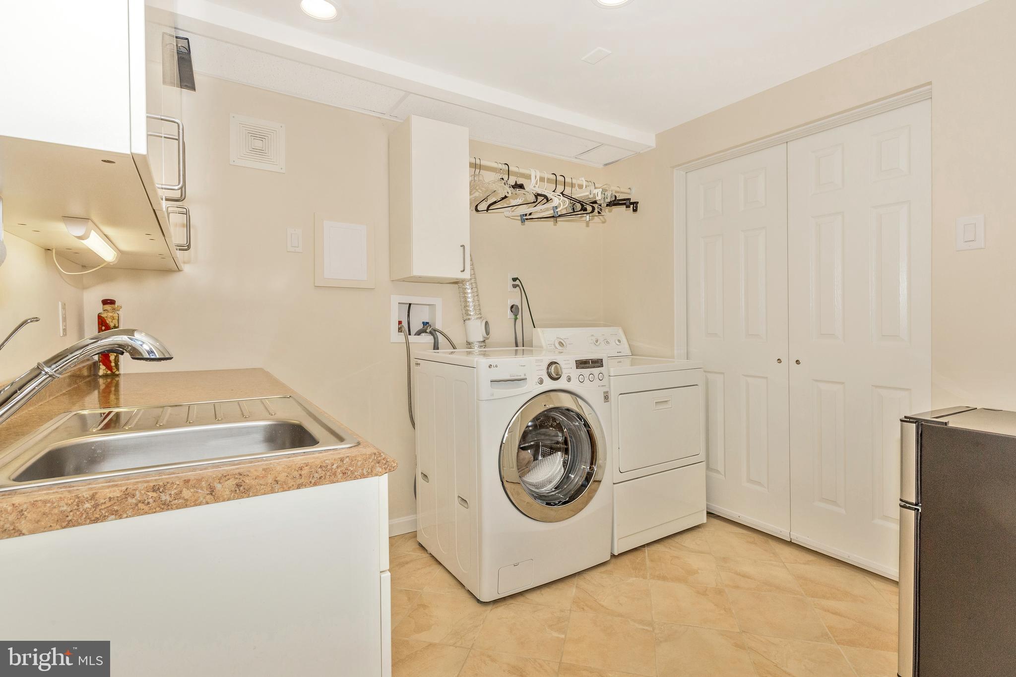 5506 Woodlyn Road Frederick, MD 21703 - Photo 36 of 51 a utility room with dryer and washer