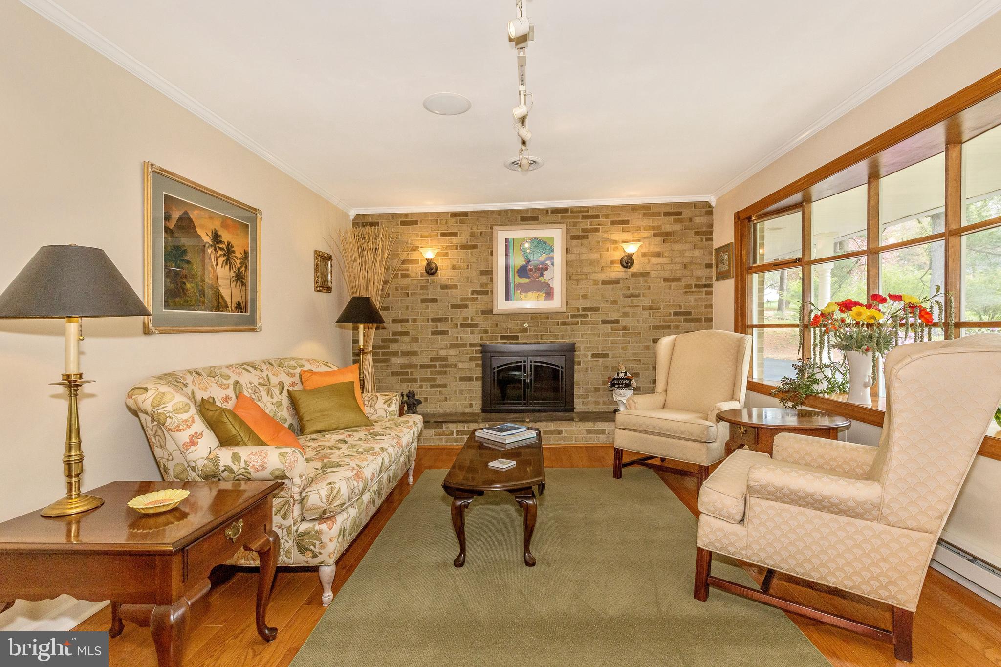 5506 Woodlyn Road Frederick, MD 21703 - Photo 6 of 51 a living room with furniture fireplace and a large window