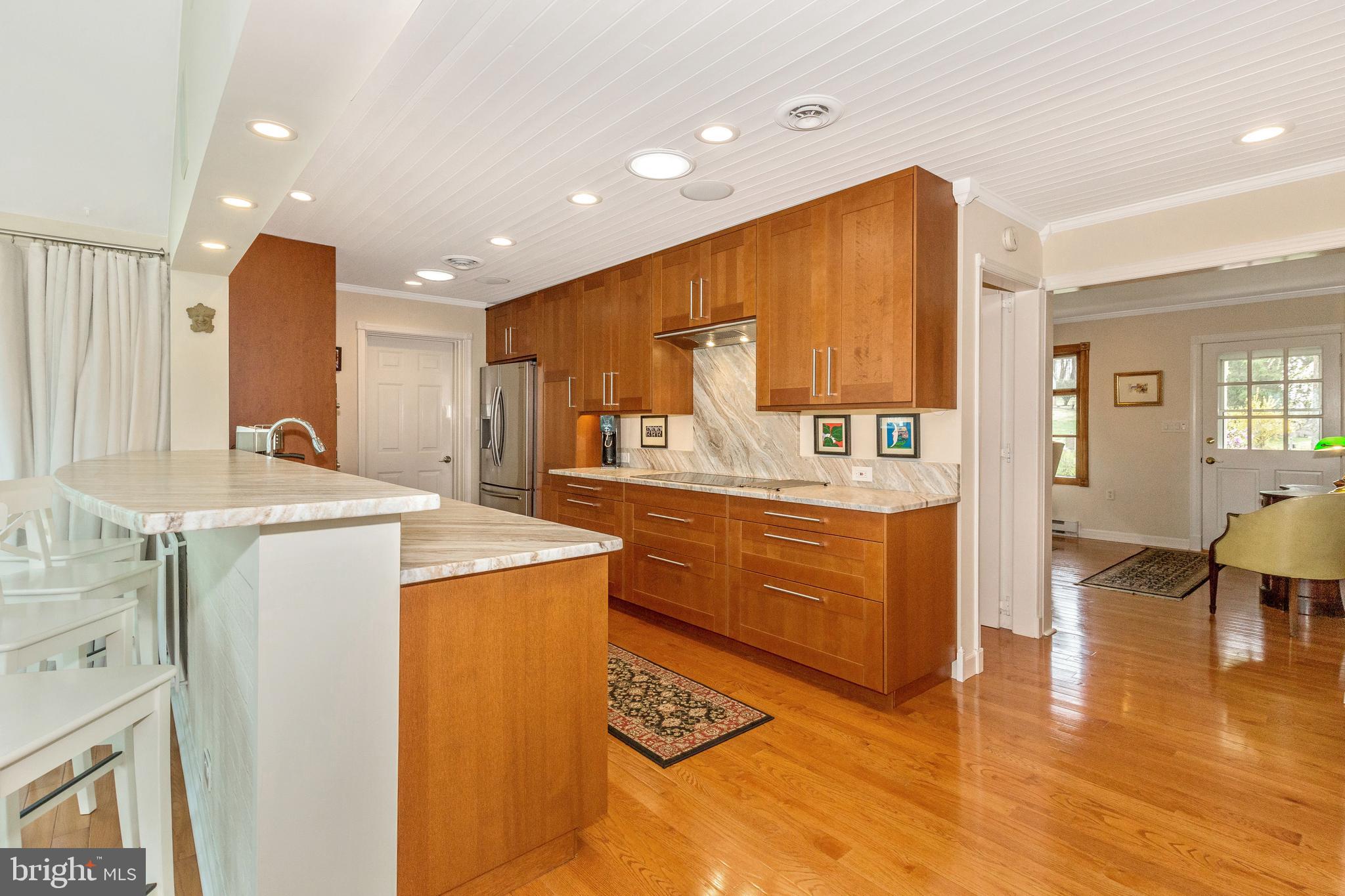 5506 Woodlyn Road Frederick, MD 21703 - Photo 10 of 51 a kitchen with kitchen island granite countertop wooden cabinets and counter space