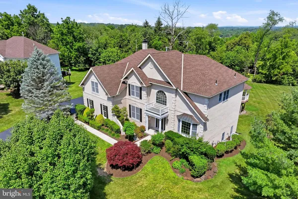 a aerial view of a house with yard and green space