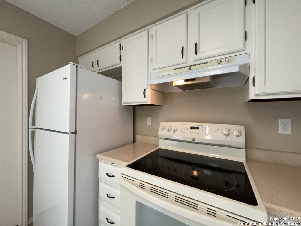309 West Highland Drive Boerne, TX 78006 - Photo 12 of 32 a white refrigerator freezer and a stove sitting inside of a kitchen