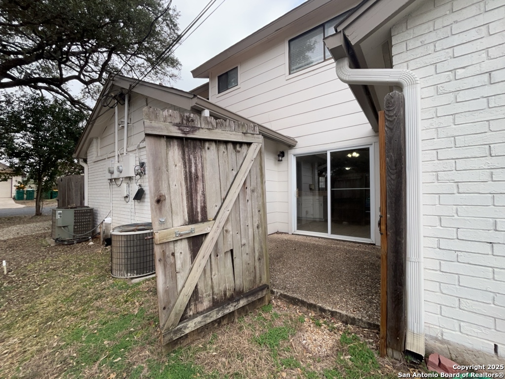 309 West Highland Drive Boerne, TX 78006 - Photo 27 of 32 a white house with a large window and potted plants