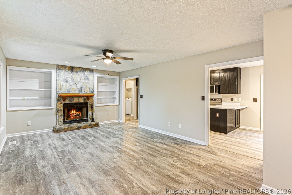 3533 Rittenour Drive Hope Mills, NC 28348 - Photo 13 of 33 a view of an empty room with a fireplace and a window