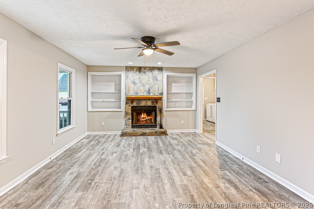 3533 Rittenour Drive Hope Mills, NC 28348 - Photo 14 of 33 an empty room with windows and fireplace ceiling fan