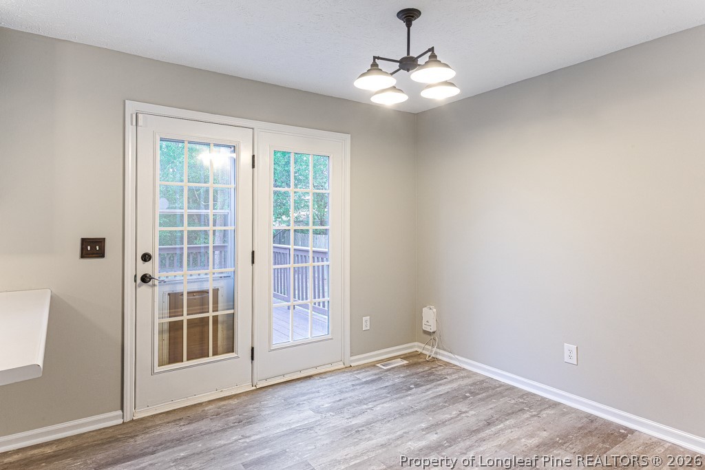 3533 Rittenour Drive Hope Mills, NC 28348 - Photo 17 of 33 a view of an empty room with wooden floor and a window