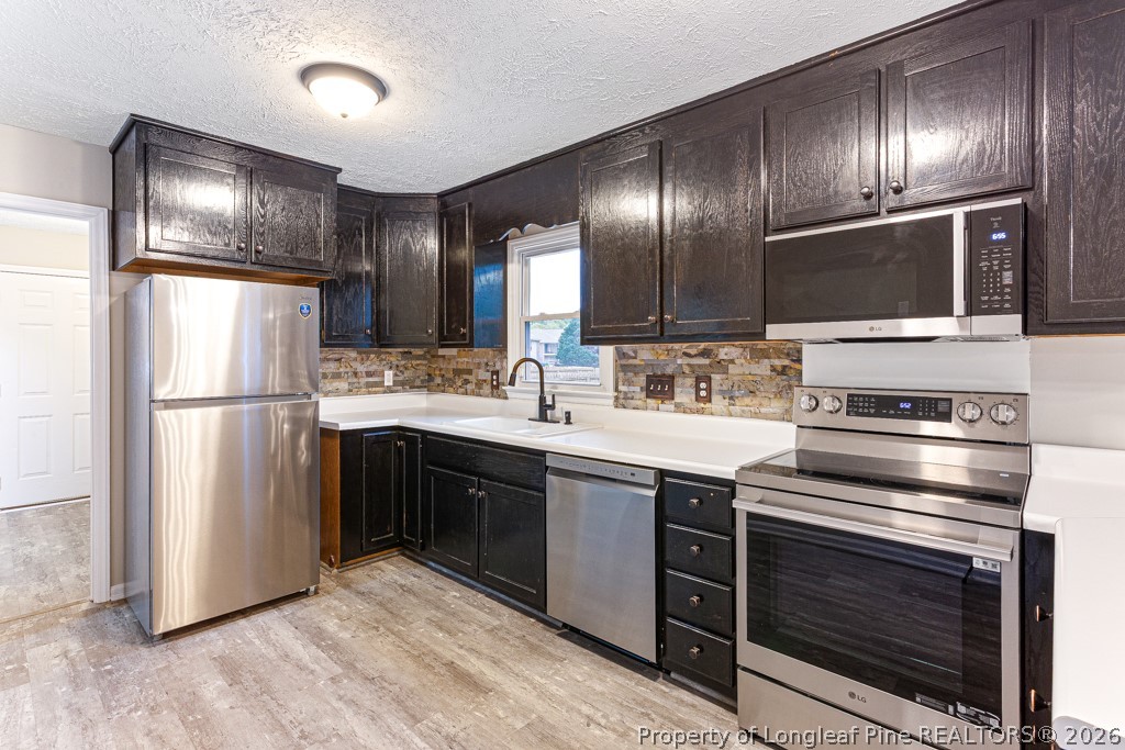 3533 Rittenour Drive Hope Mills, NC 28348 - Photo 20 of 33 a kitchen with stainless steel appliances granite countertop a stove refrigerator and cabinets