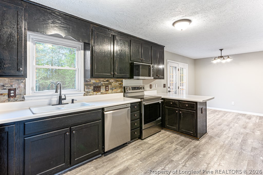 3533 Rittenour Drive Hope Mills, NC 28348 - Photo 22 of 33 a kitchen with a sink stove and cabinets