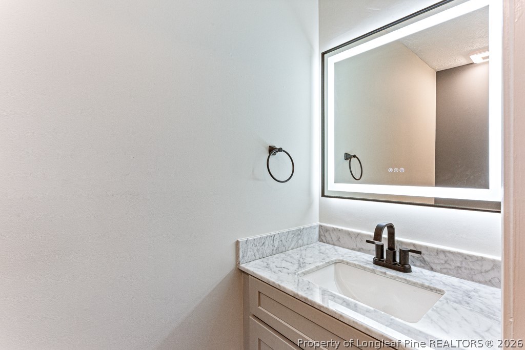 3533 Rittenour Drive Hope Mills, NC 28348 - Photo 24 of 33 a bathroom with a sink and a mirror