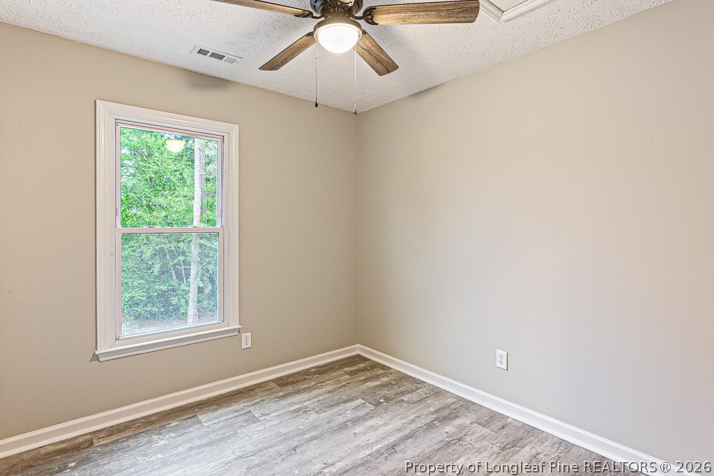 3533 Rittenour Drive Hope Mills, NC 28348 - Photo 25 of 33 an empty room with a window and a ceiling fan