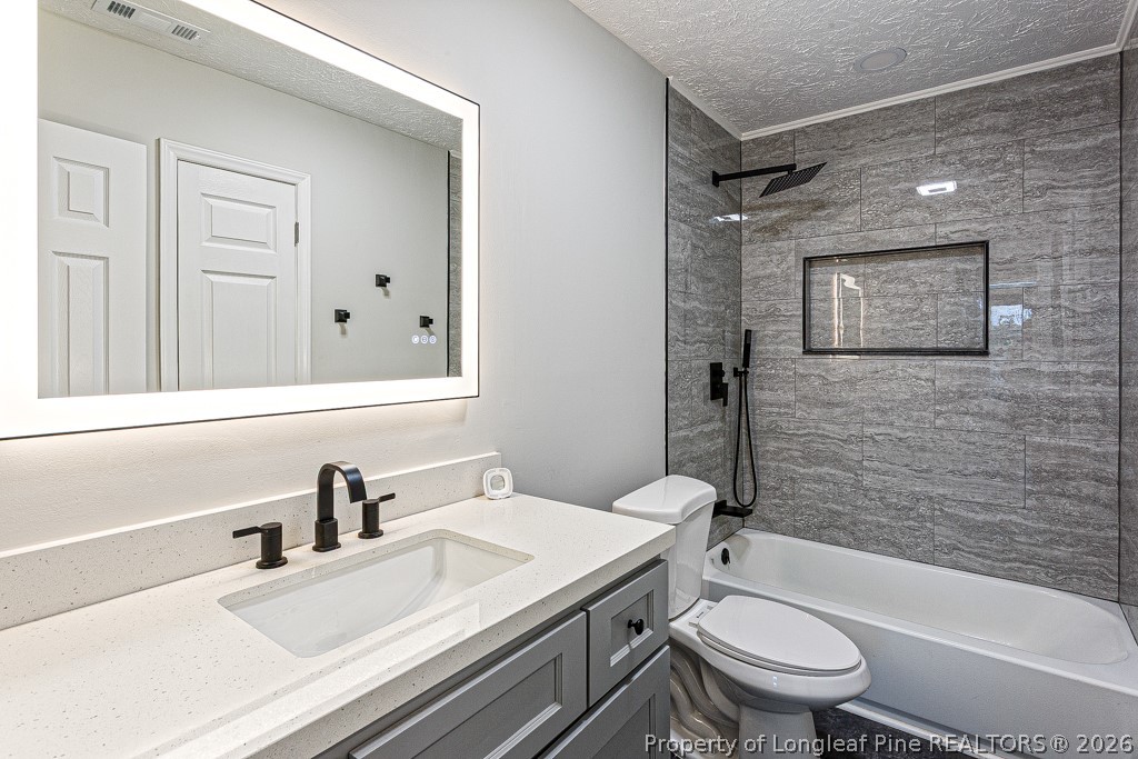 3533 Rittenour Drive Hope Mills, NC 28348 - Photo 27 of 33 a bathroom with a sink toilet vanity and shower
