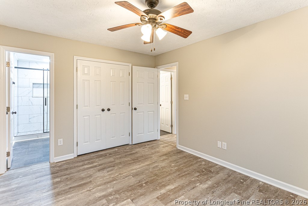 3533 Rittenour Drive Hope Mills, NC 28348 - Photo 29 of 33 a view of a room with a chandelier fan and wooden floor