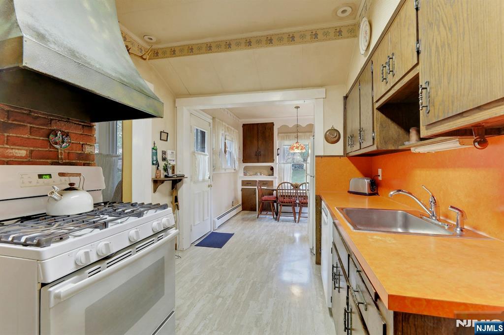 99 Armour Road Mahwah, NJ 07430 - Photo 11 of 27 a kitchen with a stove and a refrigerator