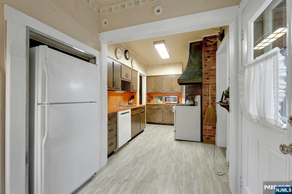 99 Armour Road Mahwah, NJ 07430 - Photo 12 of 27 a kitchen with refrigerator and white cabinets