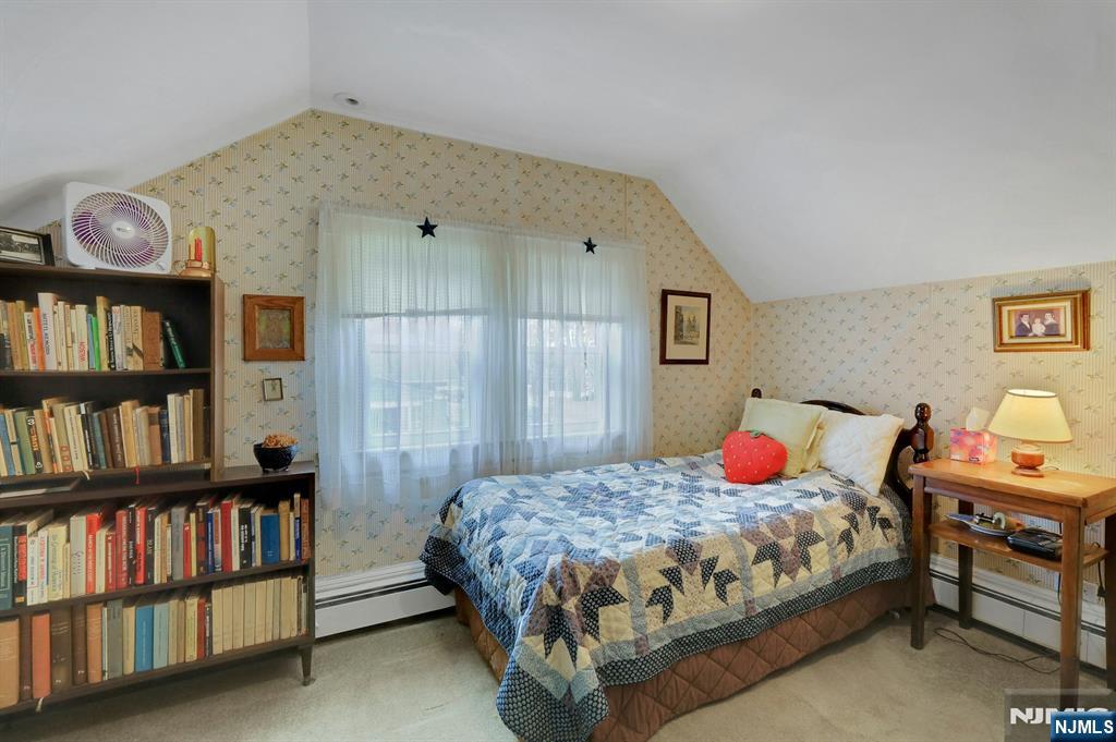 99 Armour Road Mahwah, NJ 07430 - Photo 18 of 27 a bedroom with a bed furniture and a book shelf