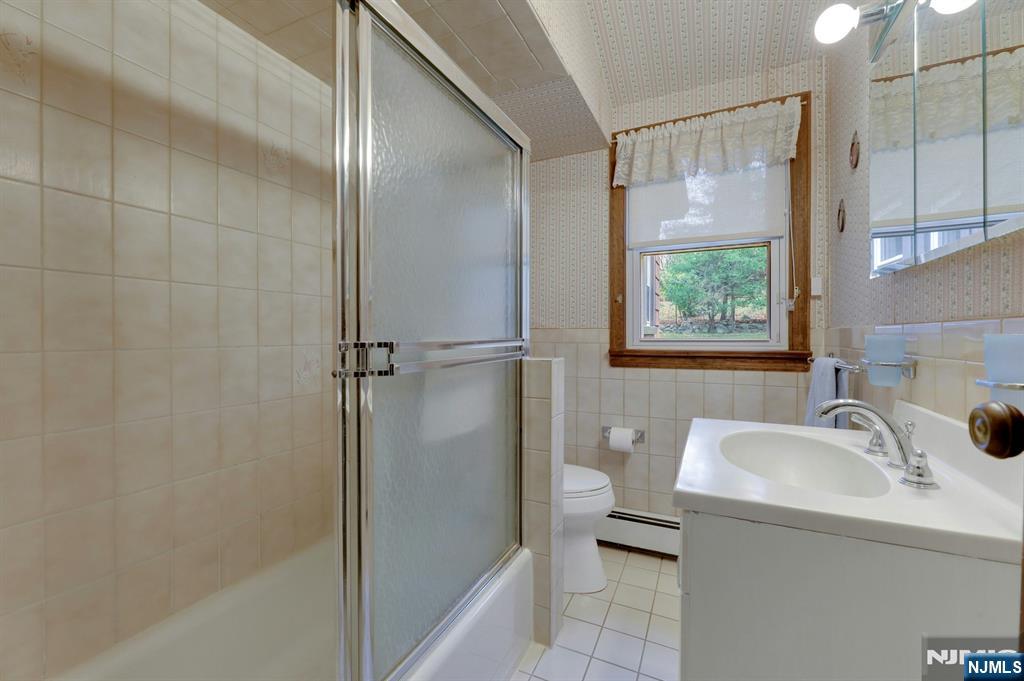 99 Armour Road Mahwah, NJ 07430 - Photo 19 of 27 a bathroom with a sink and a tub