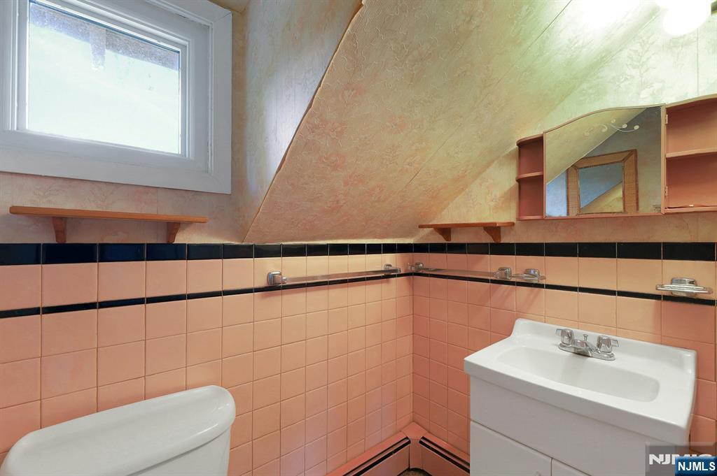 99 Armour Road Mahwah, NJ 07430 - Photo 20 of 27 a bathroom with a sink a toilet and mirror