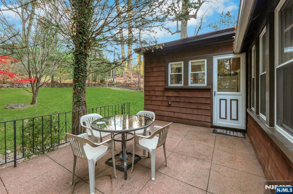 99 Armour Road Mahwah, NJ 07430 - Photo 23 of 27 a view of a patio with a table chairs and a yard