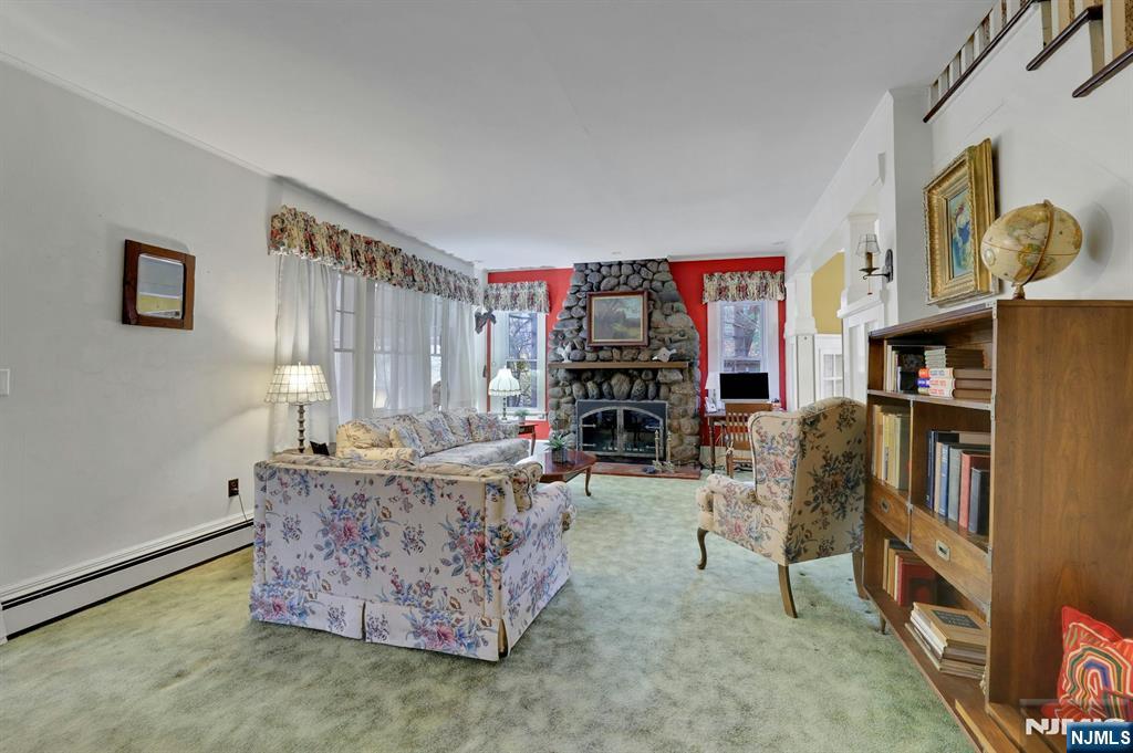 99 Armour Road Mahwah, NJ 07430 - Photo 6 of 27 a living room with fireplace furniture and a book shelf