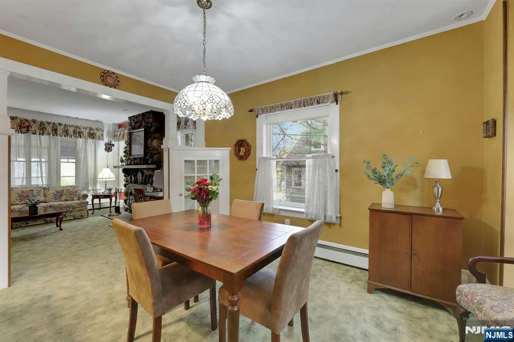 99 Armour Road Mahwah, NJ 07430 - Photo 10 of 27 a dining room with furniture a chandelier and wooden floor