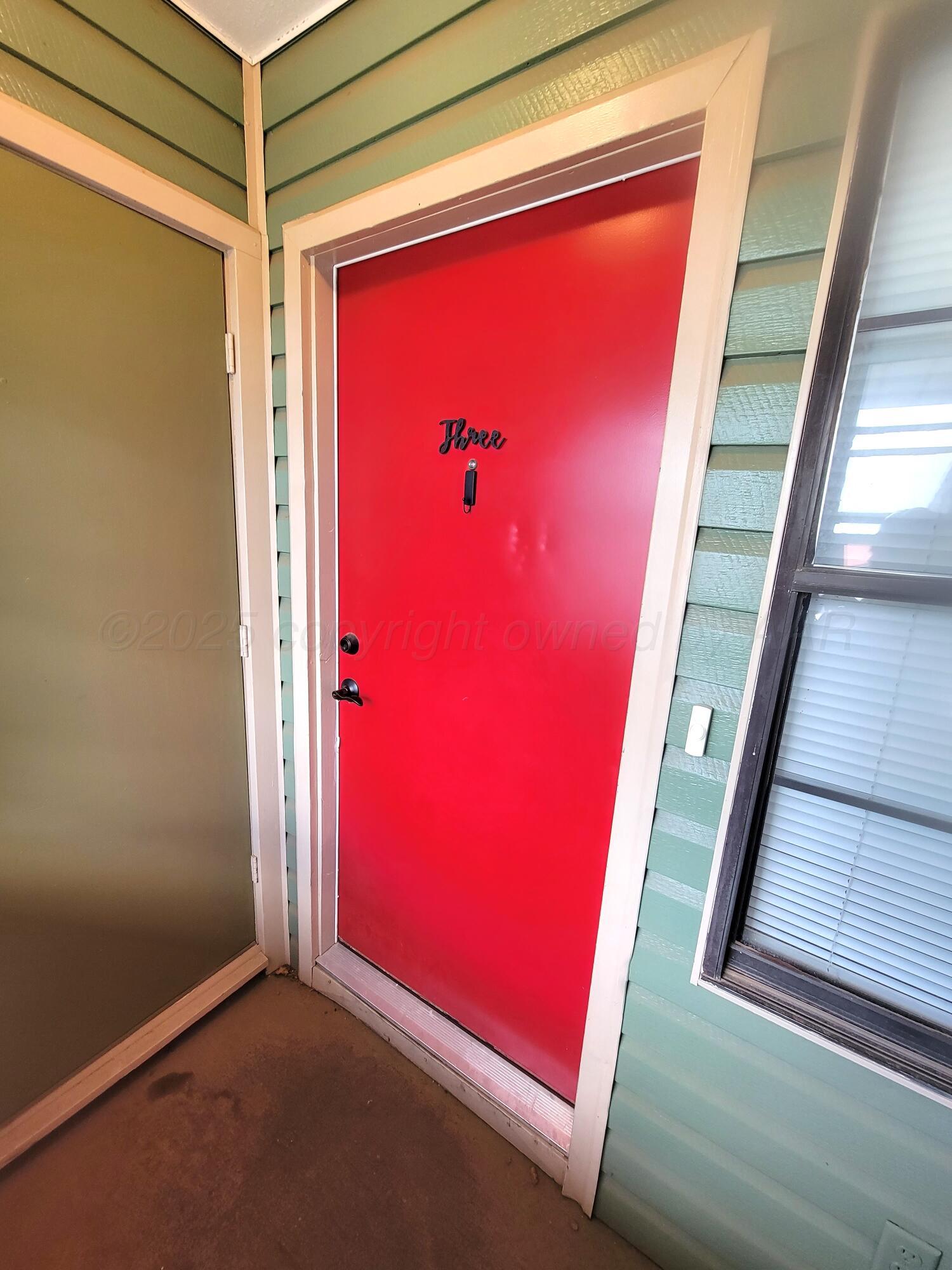 1312 Coffee Street Pampa, TX 79065 - Photo 12 of 31 a view of a red door and chair