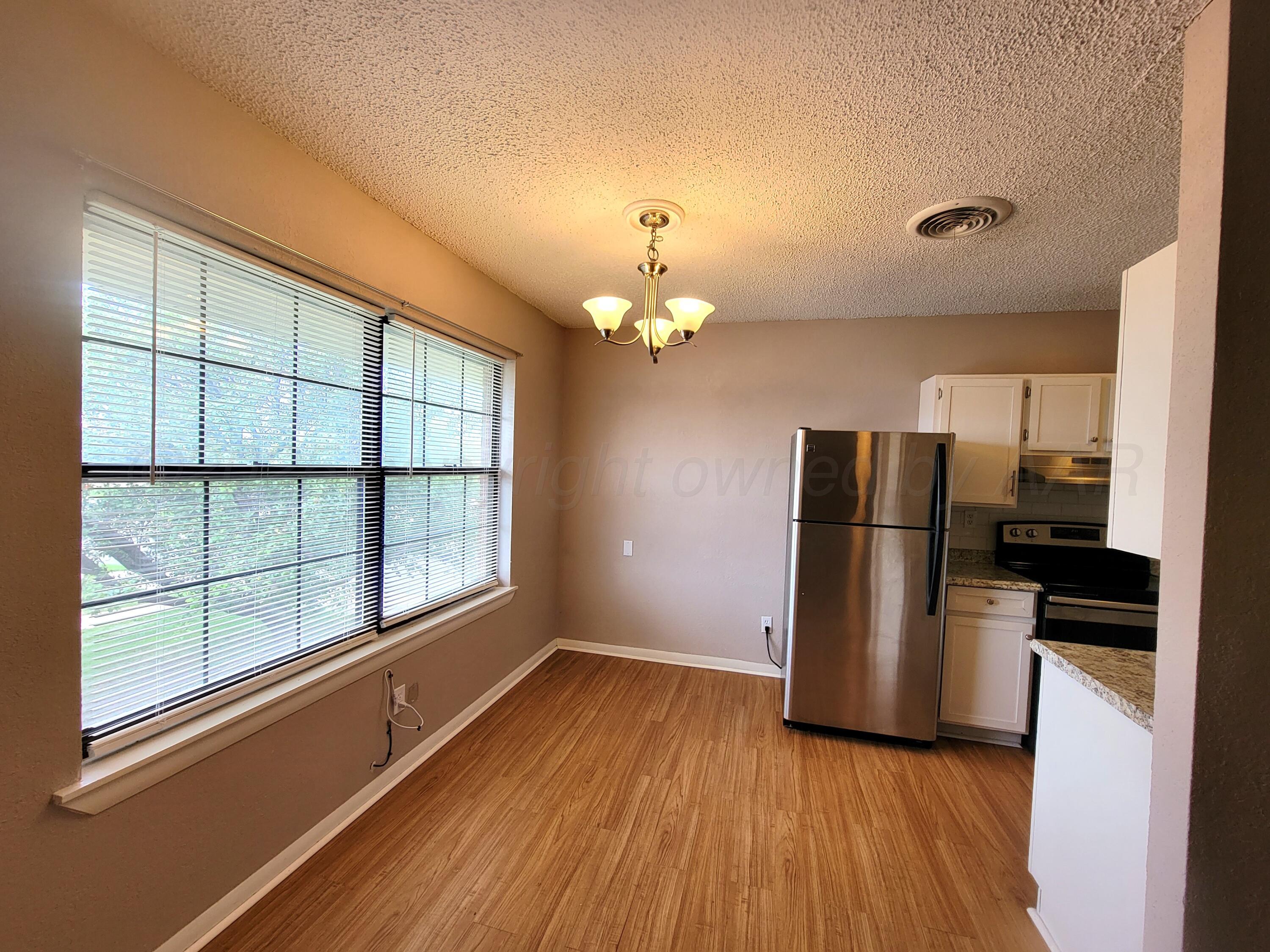 1312 Coffee Street Pampa, TX 79065 - Photo 14 of 31 a kitchen with a refrigerator and a stove top oven