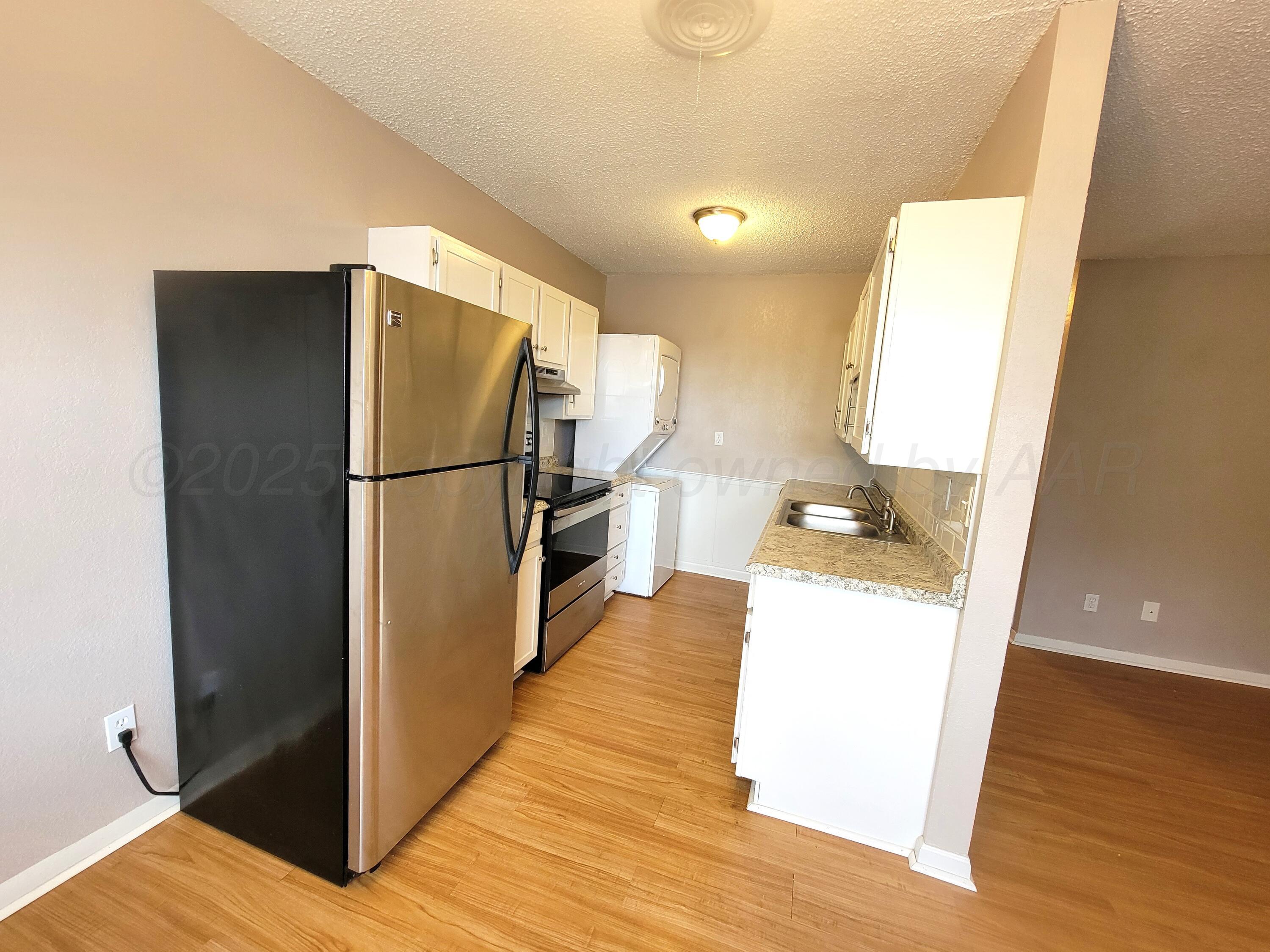 1312 Coffee Street Pampa, TX 79065 - Photo 17 of 31 a kitchen with a refrigerator a sink and dishwasher